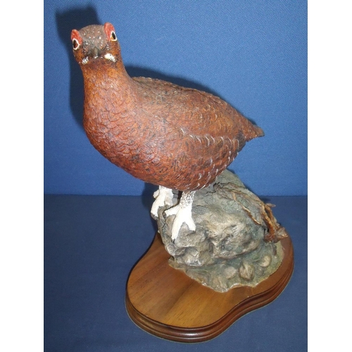 4 - Large modern figure of a grouse on rocky outcrop with wooden base (35cm high)