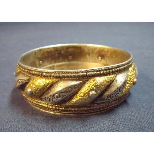 142 - Indian silver and yellow metal bangle with later fitted liner to form a dish with engraved floral de... 