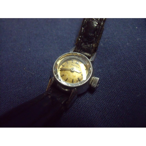 171 - Tiny ladies Omega wristwatch in stainless steel case complete with leather strap, the winder marked ... 