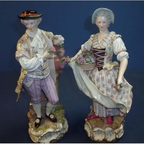 10b - Pair of Meissen porcelain figures depicting a continental couple carrying baskets of flowers with bl... 