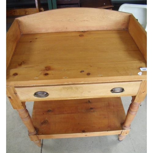 339 - Pine two tier washstand type table with raised back & sides and single drawer, above undertier on tu... 