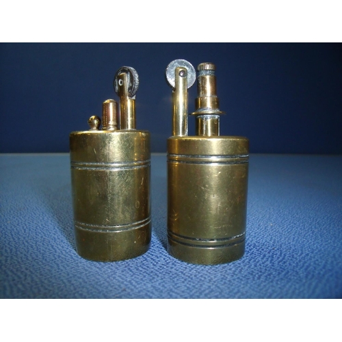 110 - Two similar brass lighters, one stamped Evva Patent W.F Austria (7cm high)