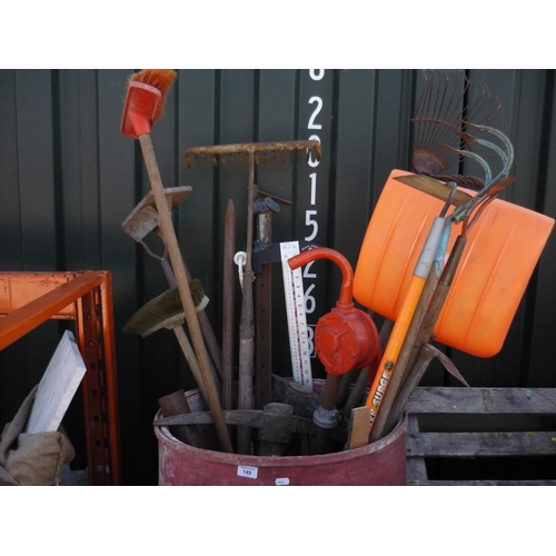 149 - Large plastic bucket full of tools consisting of racks, garden tools, water pump and pick axes