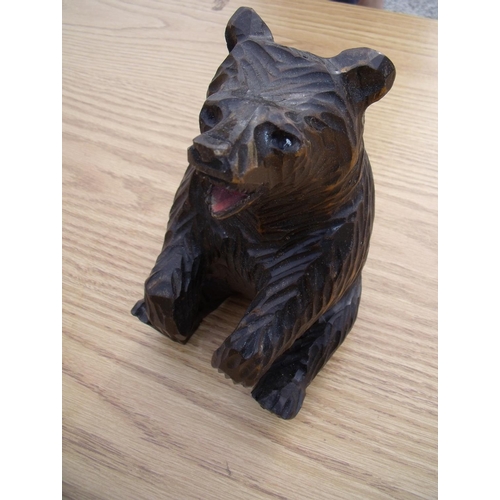 28 - Carved wood Black Forest style figure of a seated bear (22cm high)