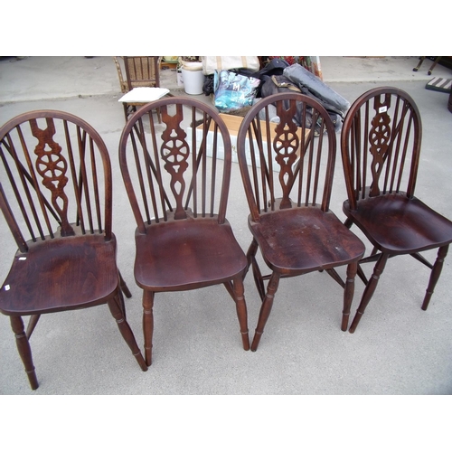 437 - Set of four oak wheel back dining chairs