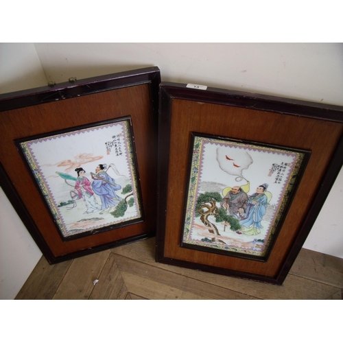 13 - Pair of wooden framed Japanese porcelain panels depicting warrior & maiden and sage type figures (39... 