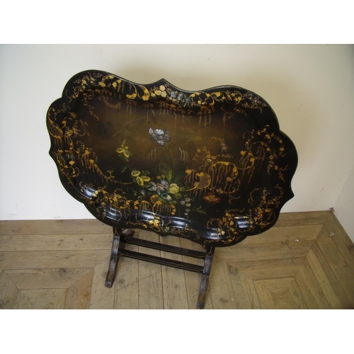 471 - Victorian folding papier-mache table on lacquered wooden stand with gilt detail, the tray with paint... 