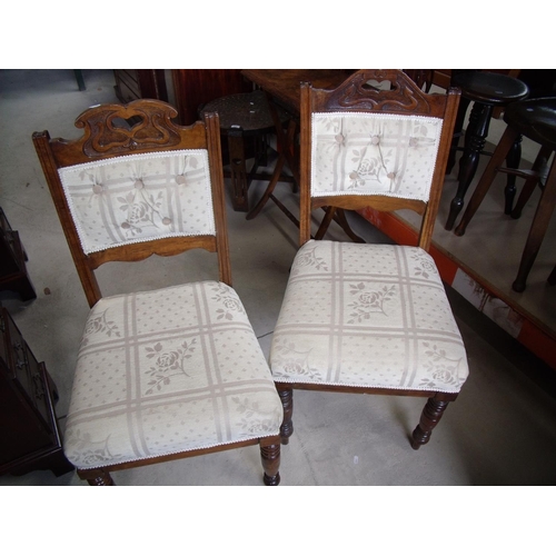 440 - Pair of early 20th C dining chairs with recently reupholstered seats and backs, with carved detail