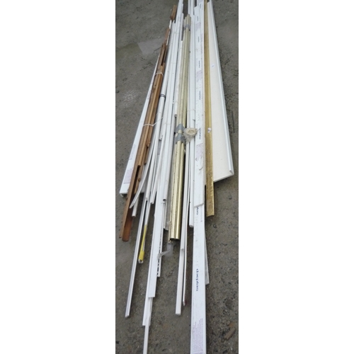 126 - Bundle of various lengths of UPVC window trims and soffit, a set of three brass effect curtain poles... 
