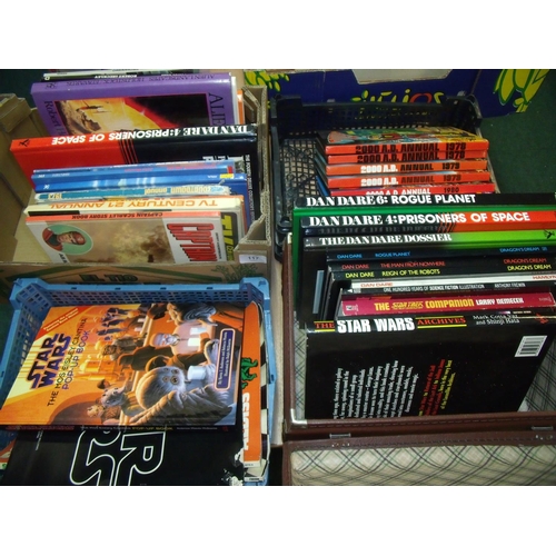 117 - Large collection of books, annuals etc in four boxes including Dan Dare 2000AD, science fiction art,... 