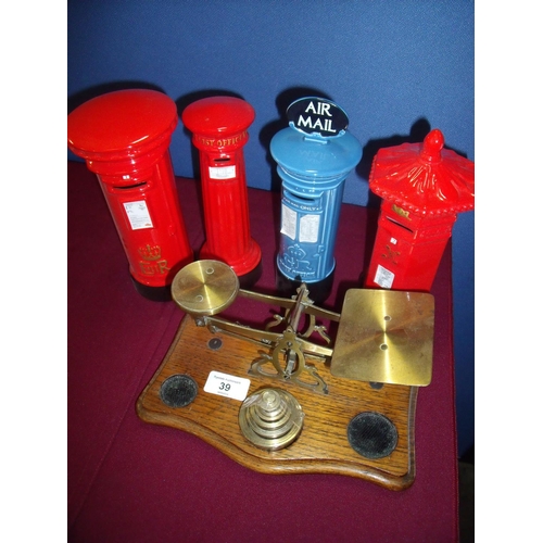 39 - Pair of brass and oak postal scales, and four ceramic Post Box money boxes (5)