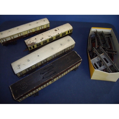 99 - Selection of O gauge railway carriages and a box of various tracks, buffer etc.