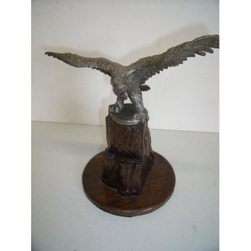 98 - Large silver plated figure of an eagle with wings outstretched mounted on carved oak rocky outcrop, ... 