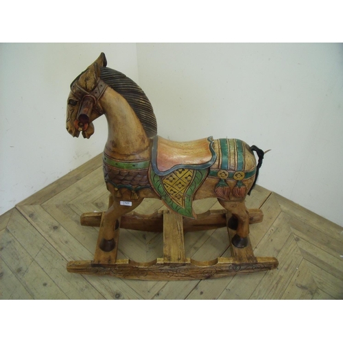 121 - Carved wood eastern style rocking horse (88cm high)