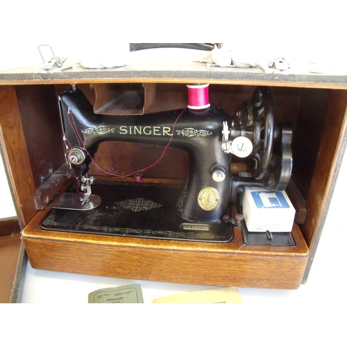 124 - Cased vintage Singer sewing machine with various instruction manuals, accessories etc, in crocodile ... 