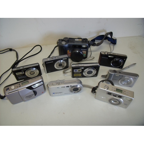 14 - Box of various compact digital cameras and a Minolta Vectis 300L compact film camera, cine camera et... 
