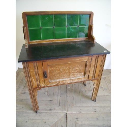 279 - Early 20th C stained beech wash stand with raised tile back and slate top, above single cupboard doo... 