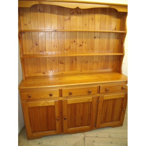 287 - Modern pine dresser with two tier raised back above three drawers and three panelled cupboard doors ... 