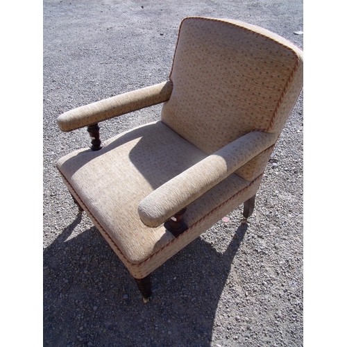 325 - Victorian mahogany framed upholstered armchair with turned front supports and brass casters