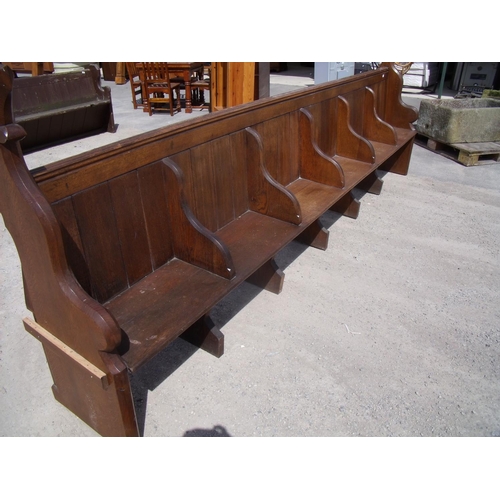 344 - Extremely long oak church style pew with seat dividers and Fleur de Lis end finials (width 370cm)