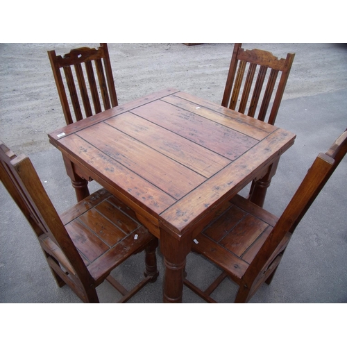 350 - Extending Mexican style hardwood table on turned supports and a set of four dining chairs