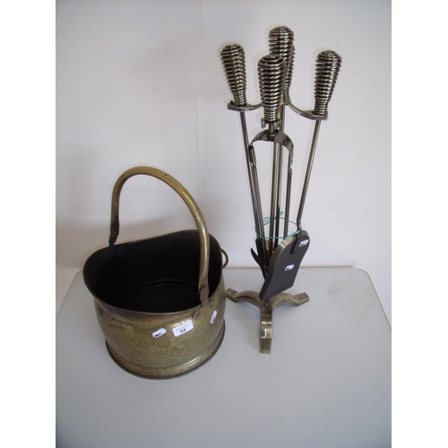 84 - Four piece fire companion set and a brass coal helmet (2)