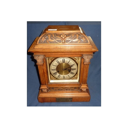 109 - Cased mantel clock with brass and steel face and  striking movement