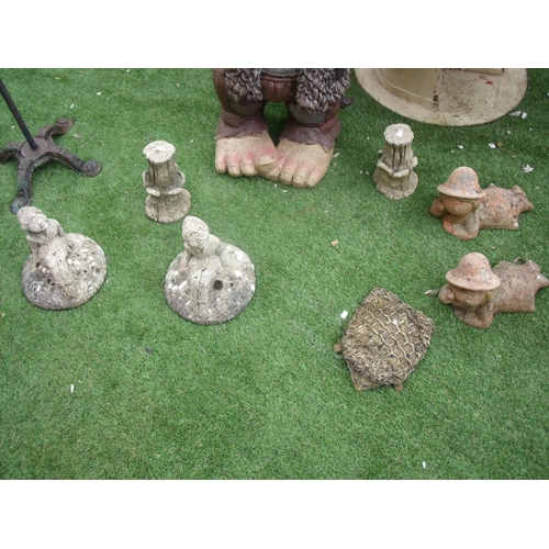 133 - Seven garden ornaments, one of which is a squashed hedgehog, and a weather vane