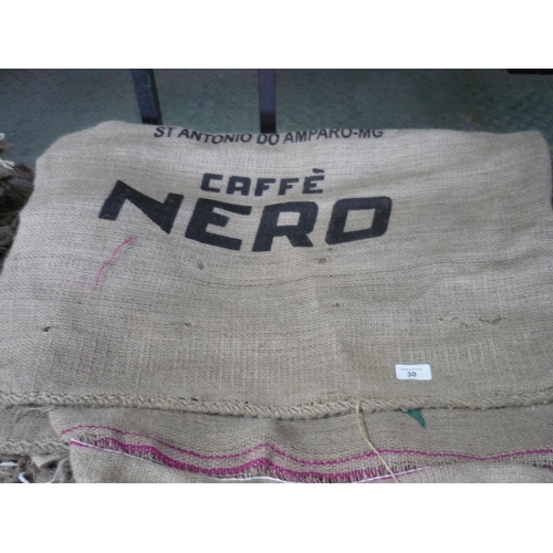 30 - Approximately 20 coffee hessian sacks with various advertisement stamps on them