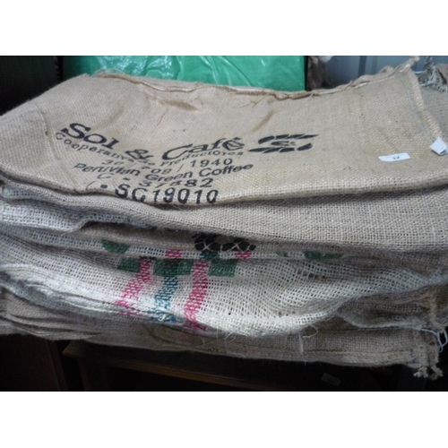 32 - Approximately 20 coffee hessian sacks with various advertisement stamps on them