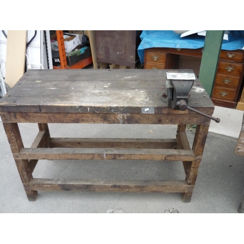 83 - A work bench with a large vice