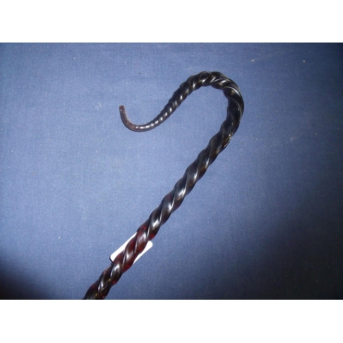 24 - 19th/20th C large twisted red glass Shepard's crook (overall length 156cm)
