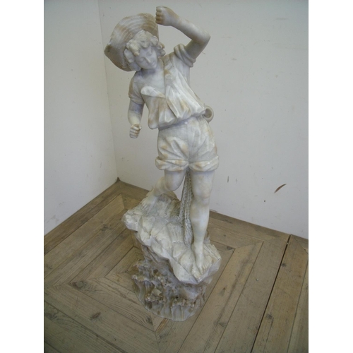 67 - Early 20th C carved alabaster figure of a boy fishing, mounted on carved rocky outcrop (94cm high) (... 