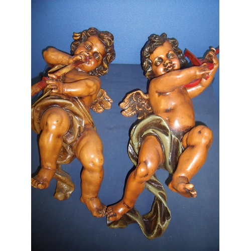 88 - Large pair of composite figures of cherubs playing instruments (approximate length 54cm)