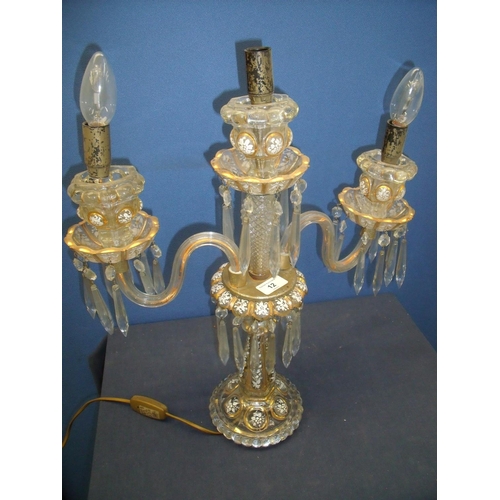 12 - Early 19th C moulded glass twin branch table lamp with painted and gilt detail (54cm high)