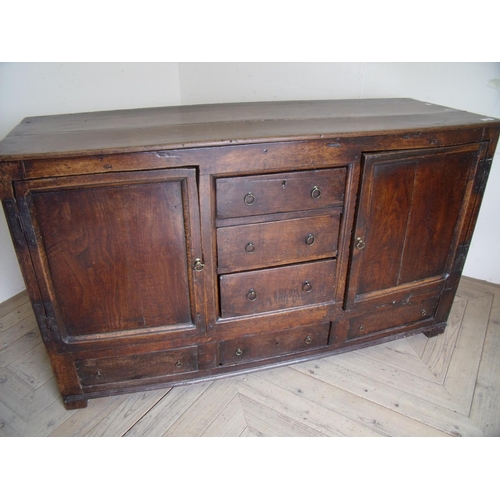 226 - Late 18th C oak dresser base with plank top and three central drawers flanked by two panelled cupboa... 