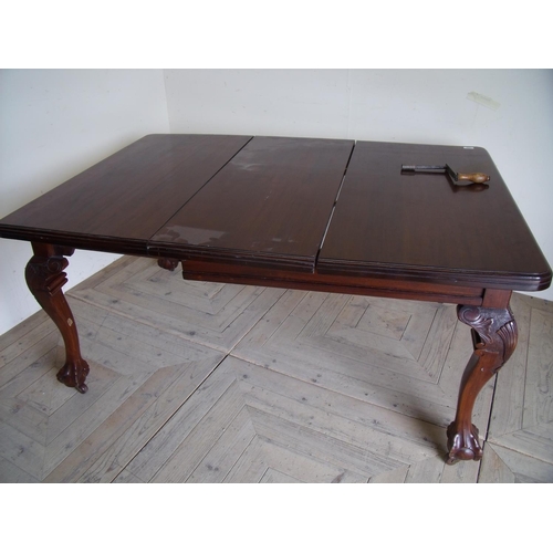 239 - Victorian mahogany wind-out extending dining table with carved supports and ball & claw feet, with a... 