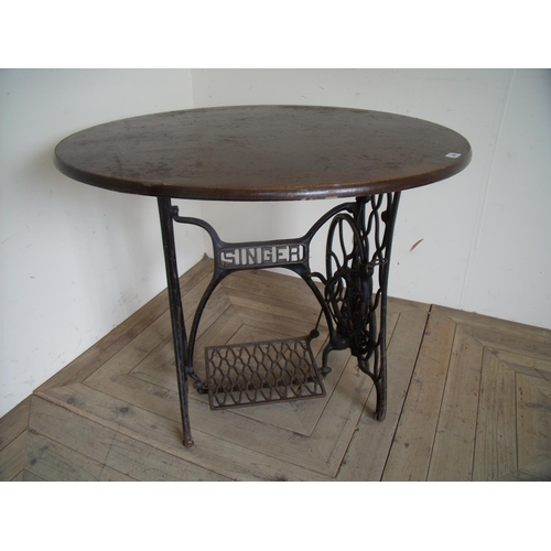 260 - Circular top table with Singer sewing machine cast metal base (diameter 90cm)