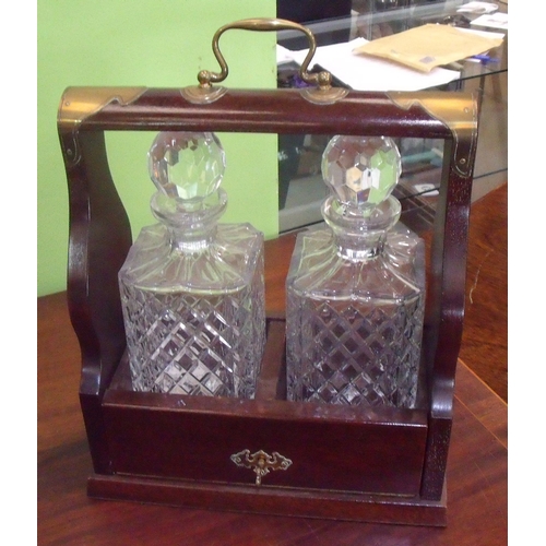 37 - Modern mahogany style and brass mounted two decanter Tantalus, with a pair of square moulded glass d... 