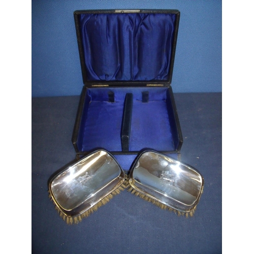 58 - Cased pair of Birmingham 1909 silver backed clothes brushes with engraved monogrammed initials B A