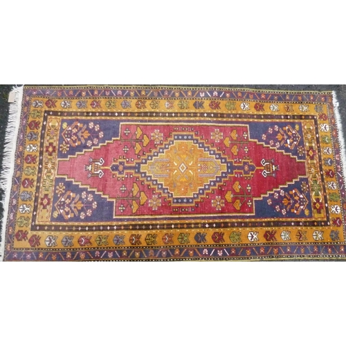 305 - 20th C red and ochre ground Persian pattern carpet with geometric centre medallion (195cm x 106cm)