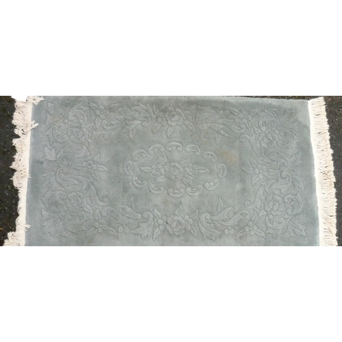 307 - Chinese embossed blue ground rug (144cm x 77cm)