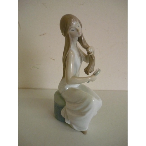 62 - Large Nao figure No.1360 of a seated girl brushing her hair (height 28cm)