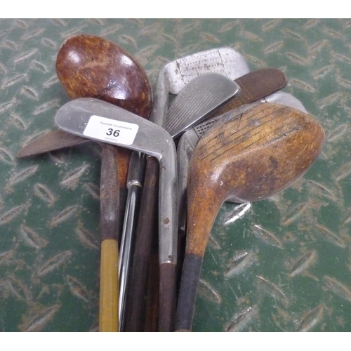36 - Set of nine vintage golf clubs