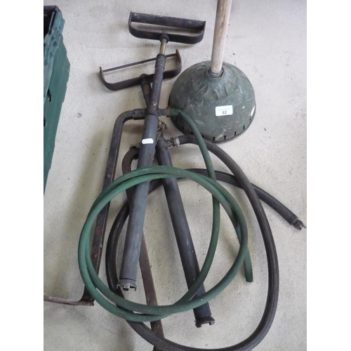 82 - Two stirrup pumps and a posser with handle