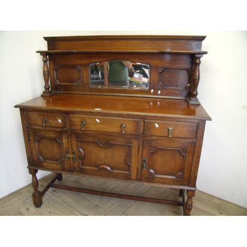 321 - Early 20th C oak mirror back sideboard with shaped bevel edged mirror, supported by turned columns, ... 