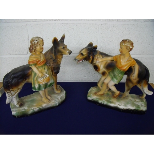 40 - Pair of large mid 20th C painted plaster figures of a boy and a girl with Alsatians (approx. 42cm hi... 