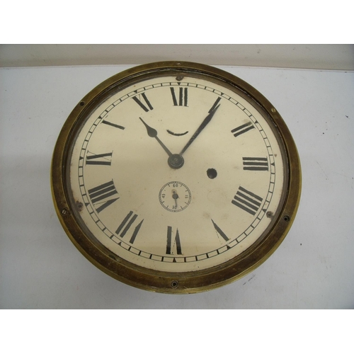 43 - Brass cased bulkhead clock (diameter 24cm)