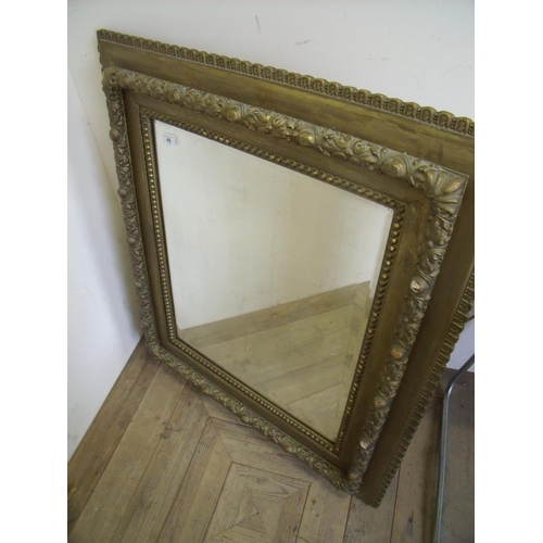 65 - Heavy gilt framed bevelled edge wall mirror (77cm x 88cm)