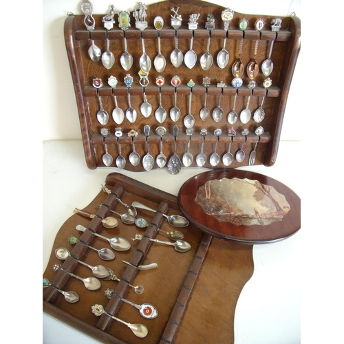 97 - Two wall mounted spoon racks containing a large quantity of various assorted spoons